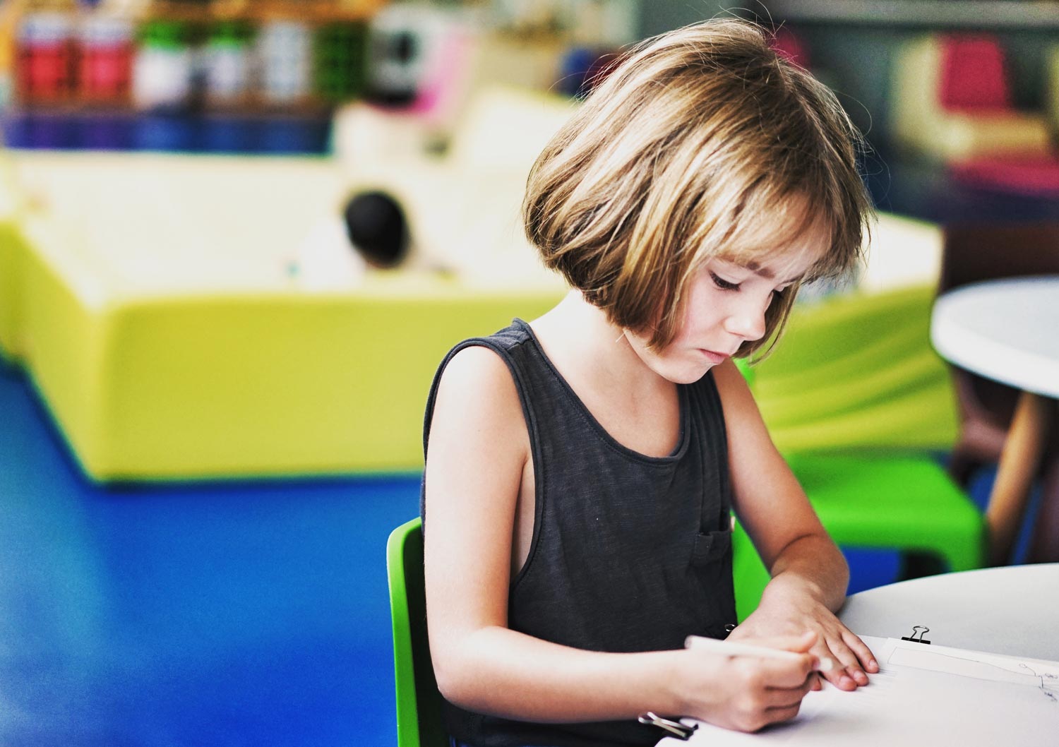 Girl seating on table writing on notebook